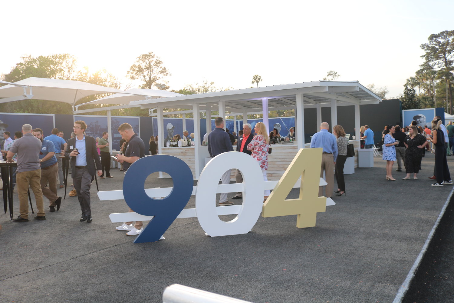 Attendees mingle around the big “904” sign at the joint after hours event at TPC Sawgrass.